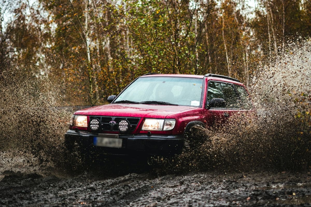 pickup truck driving through muddy terrain