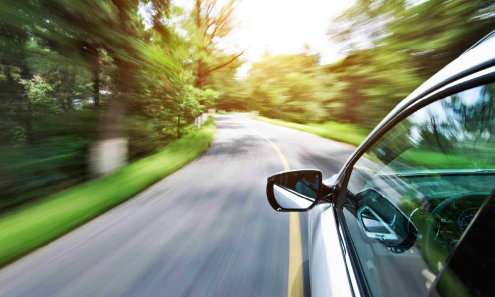 View of the side of a car driving on the open road