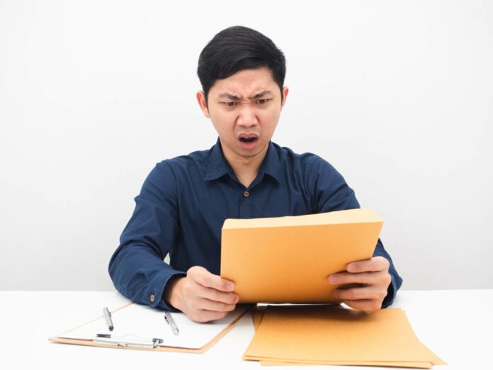 Man surprised looking at document