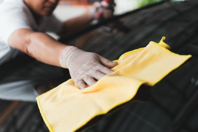 Man polishing and wiping car paint