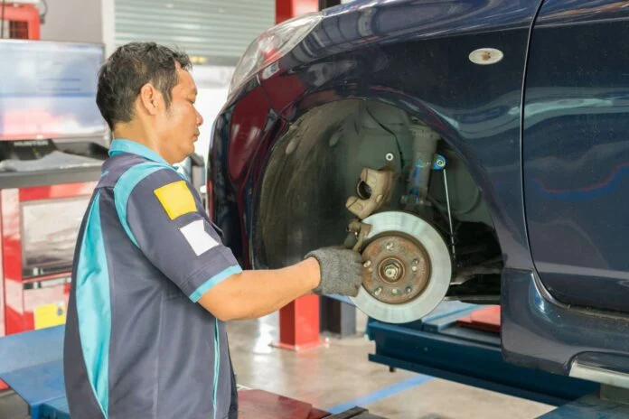 Mechanic checking car brake