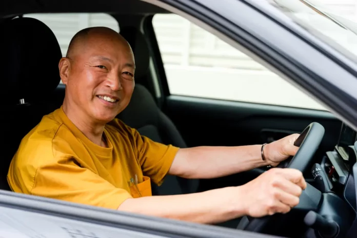 pinjaman untuk pesara, happy elder man in car driving