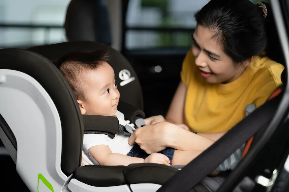 mother putting baby in baby seat in car, honda city vs toyota vios