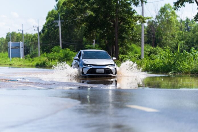 Car diving over flood water on some of the flooded area in Klang Valley