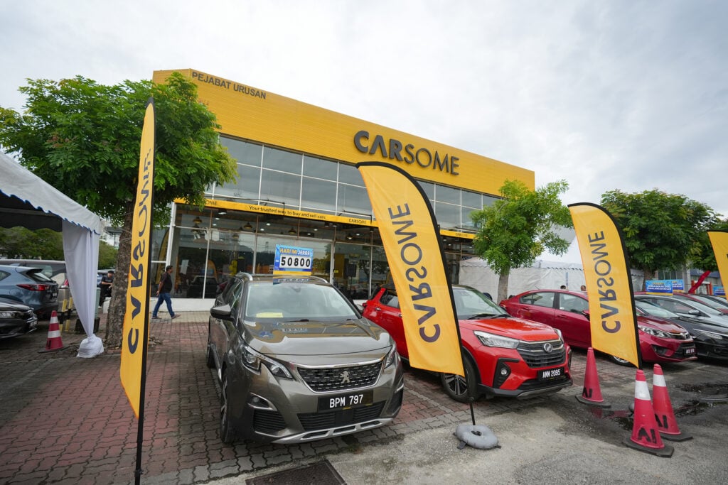 Promotional display of cars in front of CARSOME showroom for Raya campaign