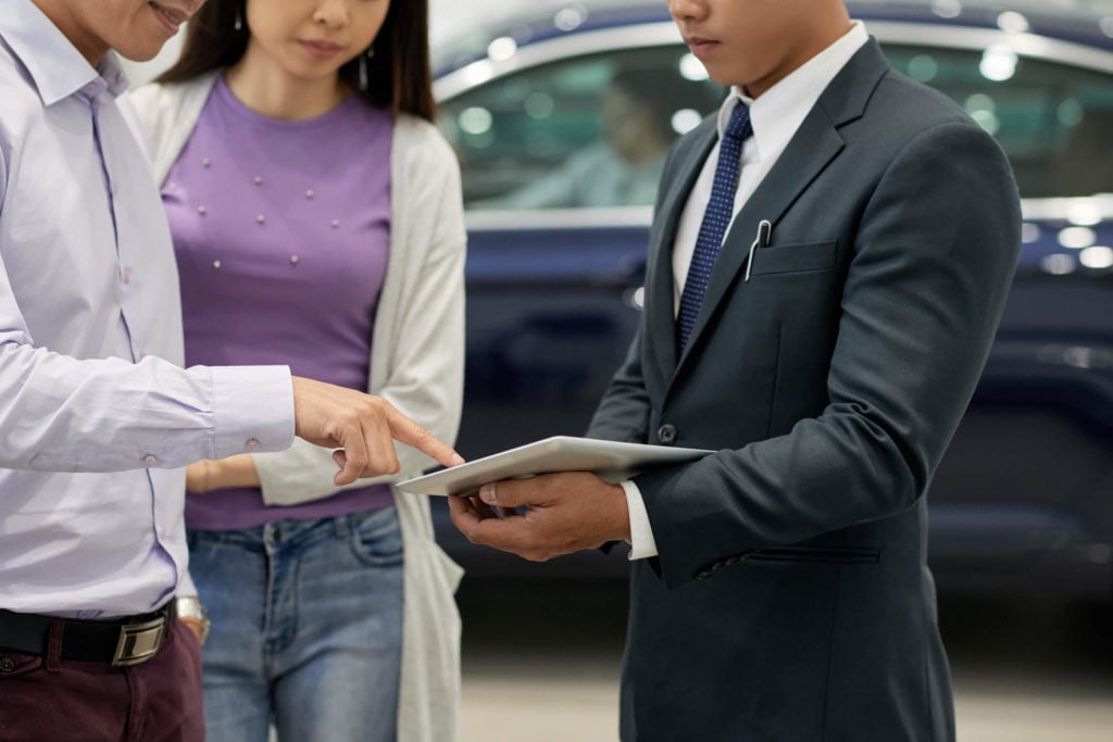 couple negotiating about car purchase