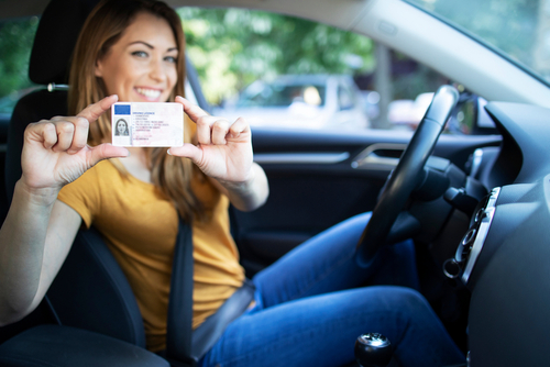 Woman holding driving license